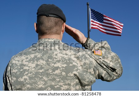 Image of an american soldier saluting the flag of the United States of America.