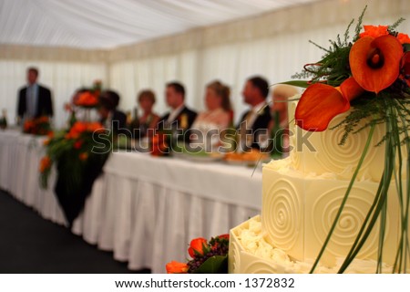 Wedding Cake with main table blurred in background