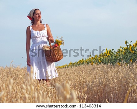 Peasant woman walk through a field with a basket full of food, Peasant woman,photography