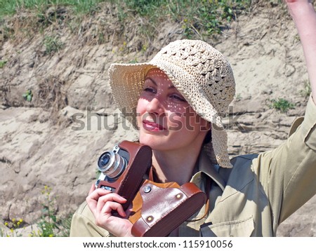 A young woman with an old camera in the desert, Old camera,photography