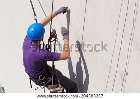 Work at height  ; Specially equipped worker performs height work,photography