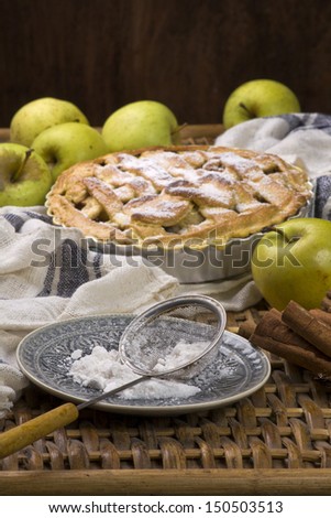 Homemade apple pie with green fresh apples and cinnamon sticks