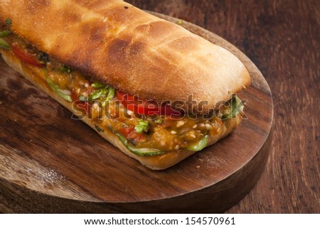 Baked vegetarian sandwich with fresh tomato and cooked aubergine