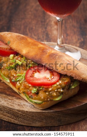 Baked vegetarian sandwich with fresh tomato and cooked aubergine
