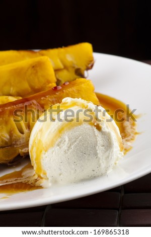 pineapple slices fried in caramel sauce with the scoop of vanilla ice cream