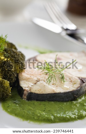 Diet healthy food. Steamed mackerel with herb sauce and broccoli
