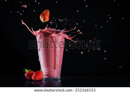 Strawberry banana smoothie with splash and copy space