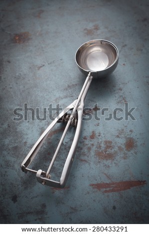 Empty Ice cream Scoop spoon on the metal table