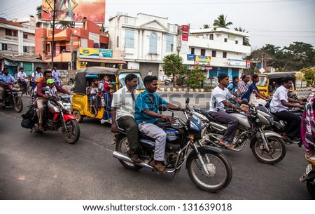 THANJAVUR, INDIA - FEBRUARY 13: Indian riders ride motorbikes on busy road on February 13, 2010 in Thanjavur, India. Motorbike is the most favorite vehicle and most affordable for India.