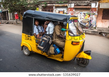 THANJAVUR, INDIA - FEBRUARY 13: unidentified Children go to school by auto rickshaws February 13, 2013 in Thanjavur, India. Indian government lays emphasis to primary education up to the age of fourteen years.