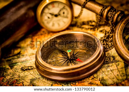 Vintage still life Vintage compass lies on an ancient world map Vintage still life Vintage compass lies on an ancient world map