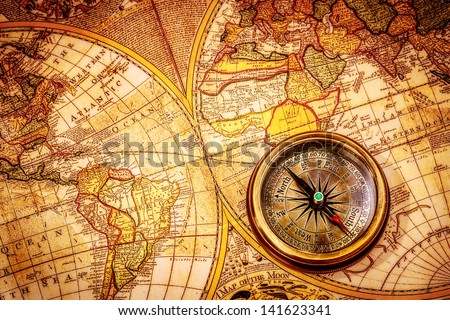 Vintage still life. Vintage compass lies on an ancient world map.