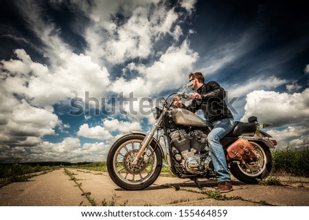 Biker In Sunglasses And Leather Jacket On The Road