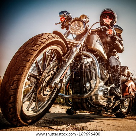 Moscow, Russia-July 7, 2013: Biker Girl On Legendary Bike Harley Sportster (Focus On The Wheel).Harley-Davidson Sustains A Large Brand Community Which Keeps Active Through Clubs, Events, And A Museum.