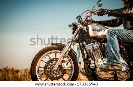 MOSCOW, RUSSIA-JULY 7, 2013: Biker on Legendary bike Harley Sportster. Harley-Davidson sustains a large brand community which keeps active through clubs, events, and a museum.