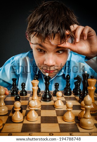 Wunderkind play chess. Funny Nerd boy.