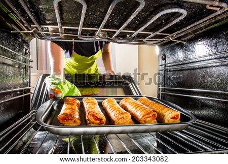 Housewife preparing cakes in the oven at home, view from the inside of the oven. Cooking in the oven.