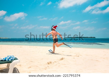Christmas vacation - man in santa hat on the Maldives tropical beach