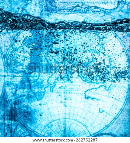 Many bubbles in water close up, abstract water wave with bubbles. Against the background of an ancient map of the world