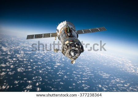 Spacecraft Soyuz orbiting the earth. Elements of this image furnished by NASA.