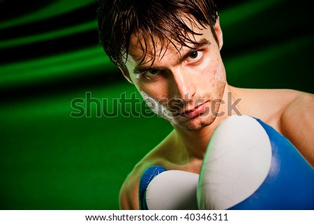 Man sweating all over in boxing gloves...