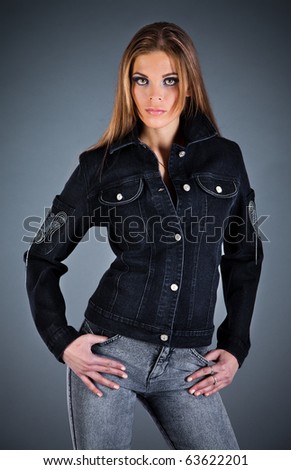 beautiful girl in a jeans jacket on the dark