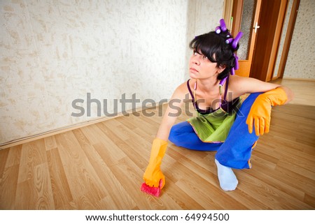 housewife sits on a floor and cleans a floor