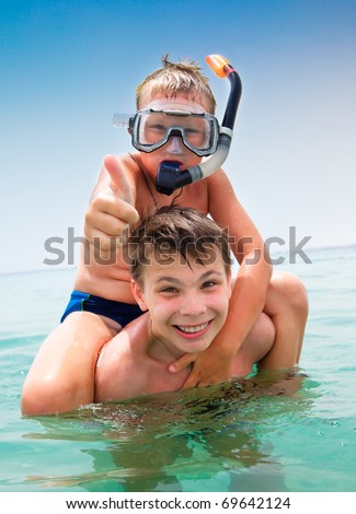 Two boys in the sea on a beach Two boys in the sea on a beach