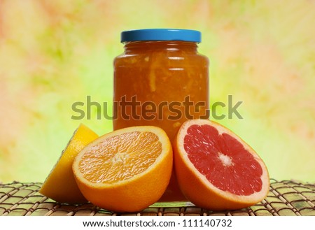 jar of citrus marmalade with some fresh fruits
