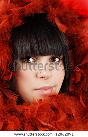 closeup portrait of a teen girl with red feather boa