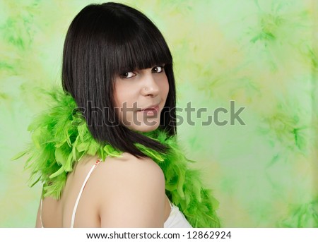 closeup portrait of a teen girl with green feather boa