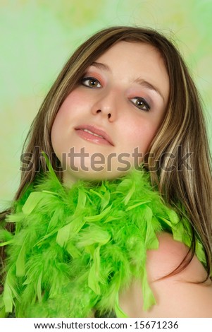 portrait of a young woman with green feather boa