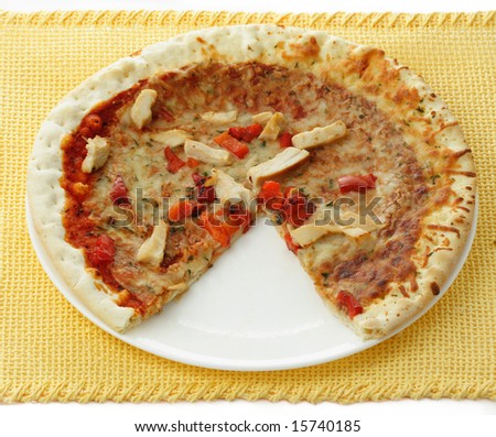 chicken pizza with a slice missing, white plate, yellow tablecloth