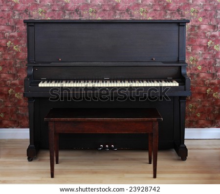 dark brown piano with bench