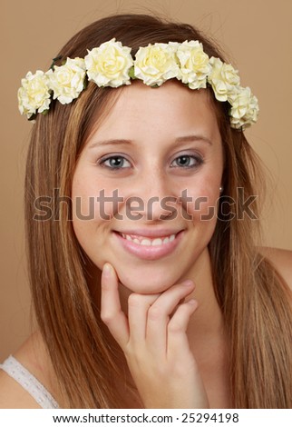young caucasian woman with crown of fake flowers