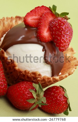 vanilla ice-cream in a wafer basket with chocolate and strawberries