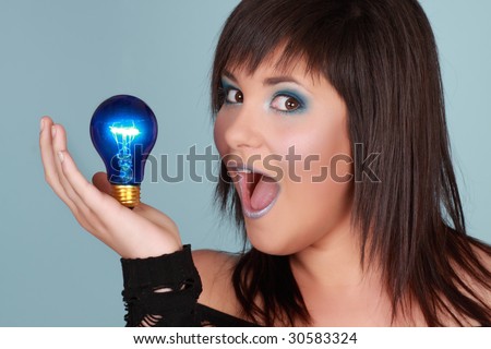 young woman holding a blue lightbulb