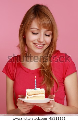 cute girl looking at vanilla birthday cake