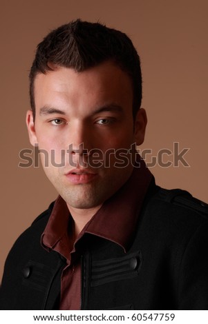 portrait of a cute young man, beige background