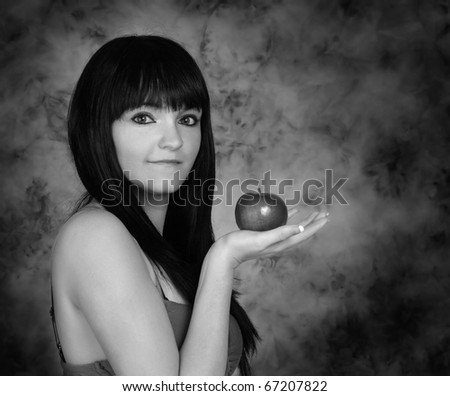 black and white image of cute young woman holding an apple