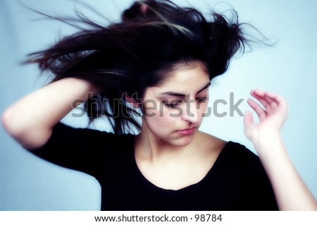 casual woman posing, hair is blown by wind