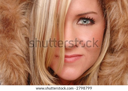 beautiful woman\'s face close up covered by fur