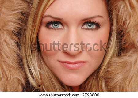 beautiful woman\'s face close up covered by fur