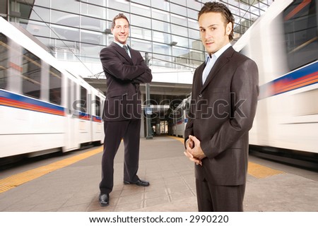 business team is posing against moving trains