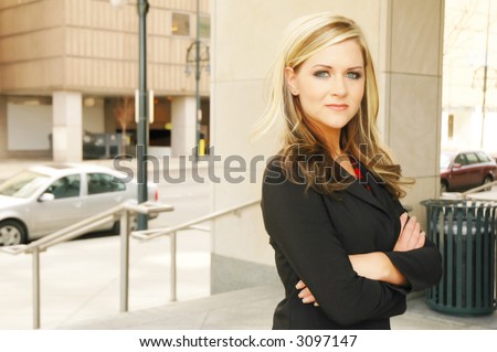 business woman posing in a business setting in front of business buildings