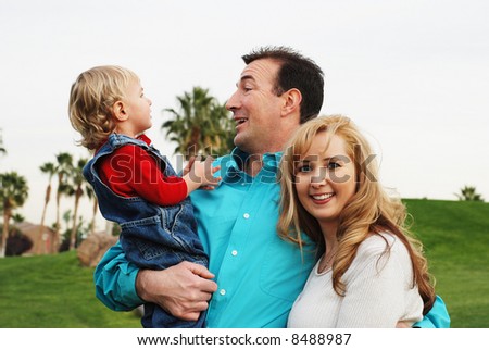 happy couple with a child smiling and enjoying their time together