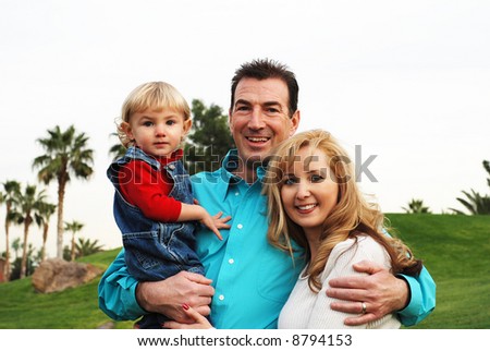 happy couple with a child smiling and enjoying their time together