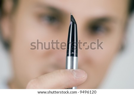 businessman holding a pen in his hands, close up of pen