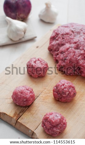Cooking meatballs from ground beef raw vertical