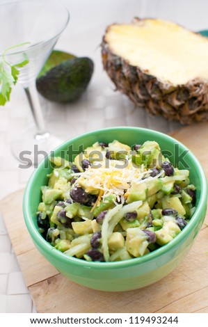 Pineapple, avocado, onion and beans salad vertical